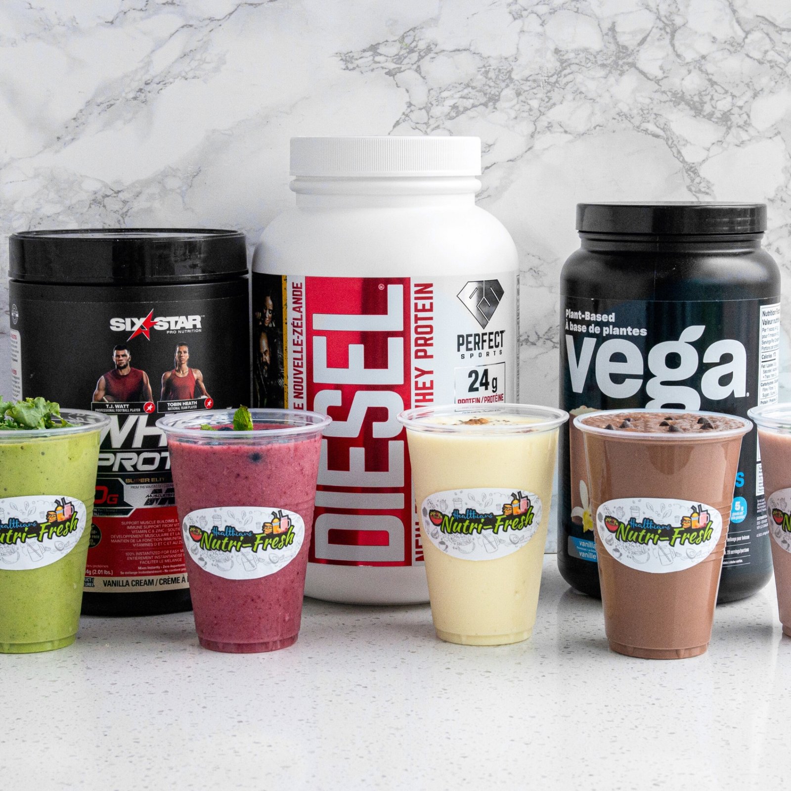 Lineup of Nutri-Fresh protein smoothies in clear cups with protein powders behind